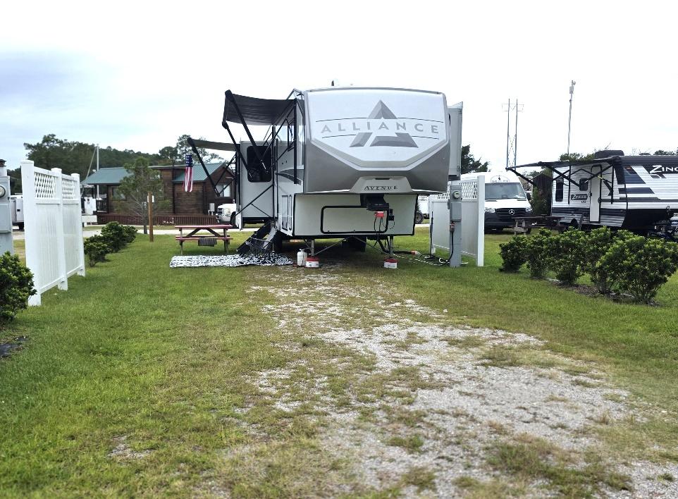Pull-through RV site RV11-165 occupied by a fifth-wheel camper