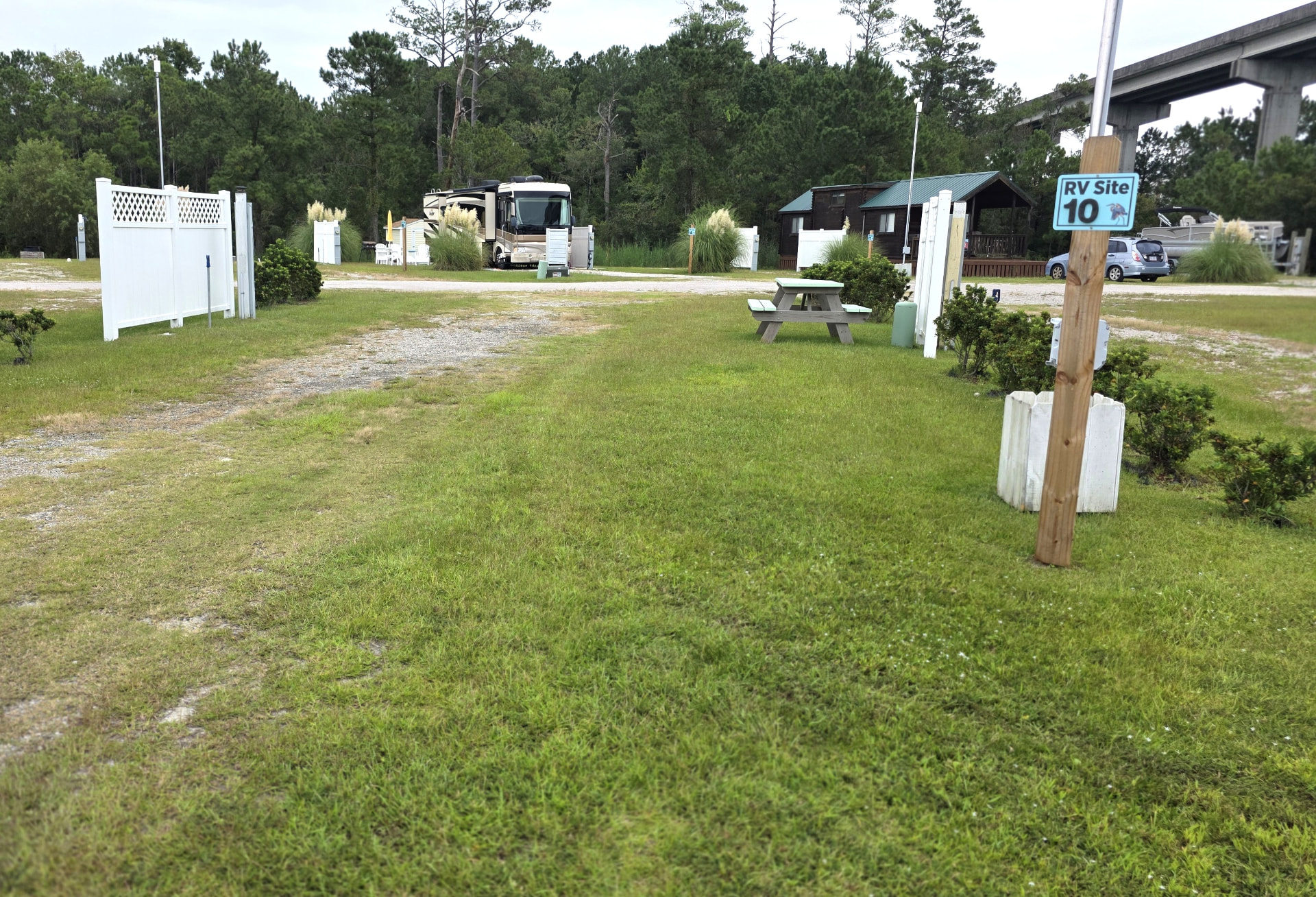 RV site 10 with a long gravel pad, lawn and picnic table