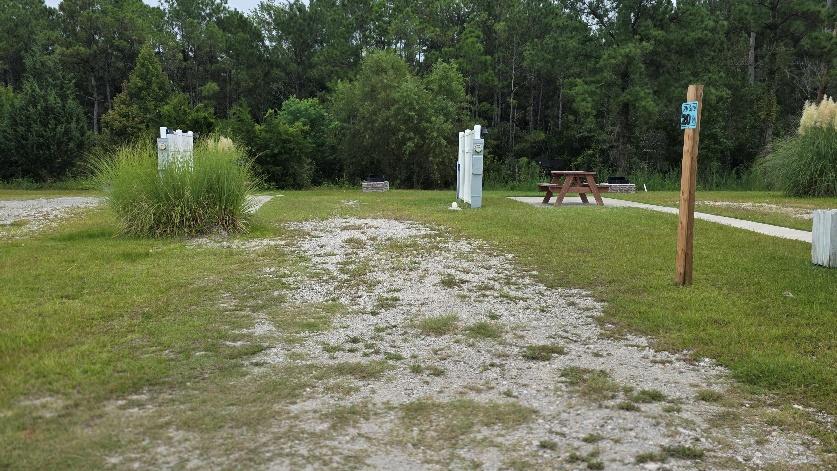 Back-in RV site RV20-168 with a gravel pad and picnic table