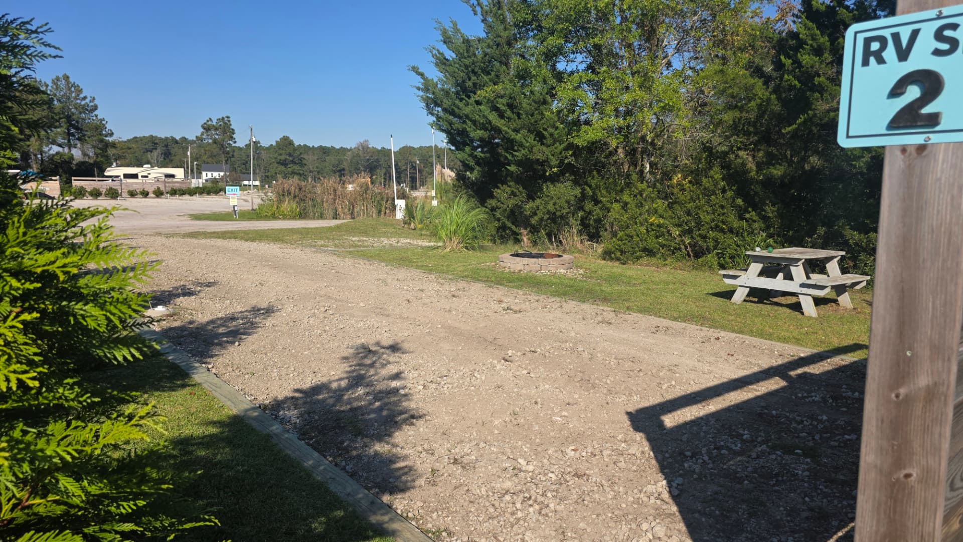 Core Creek site CCR2-121 from the opposite side, showing the gravel pad, fire pit and picnic table on the lawn