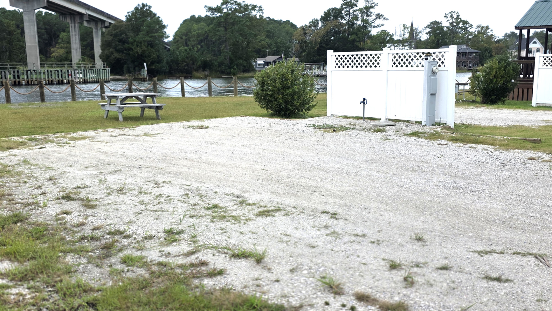 Waterfront RV site 7 with a gravel pad, picnic table and utility connections