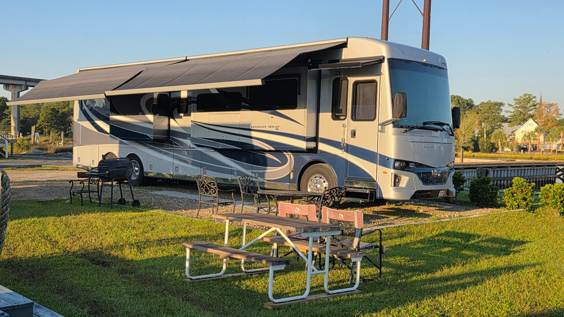 Motorhome at Core Creek site CCR3-120 beside the marina with a picnic table