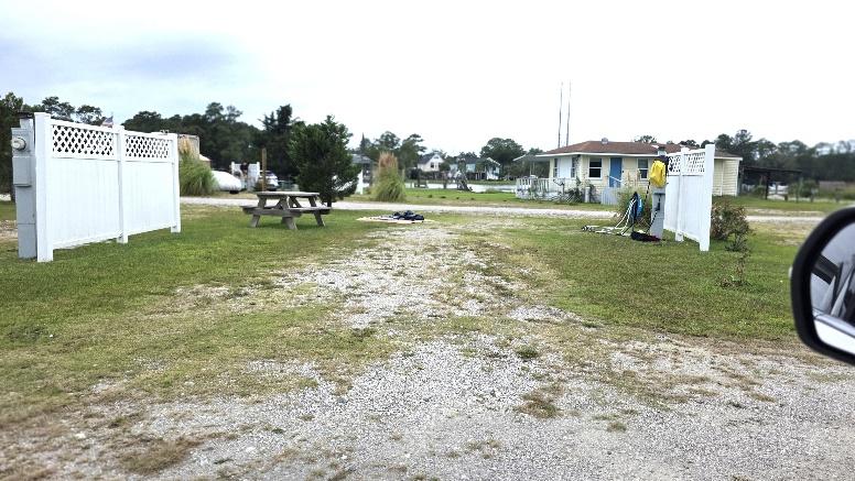 Economy pull-through RV site RV15-173 with a gravel pad and picnic table