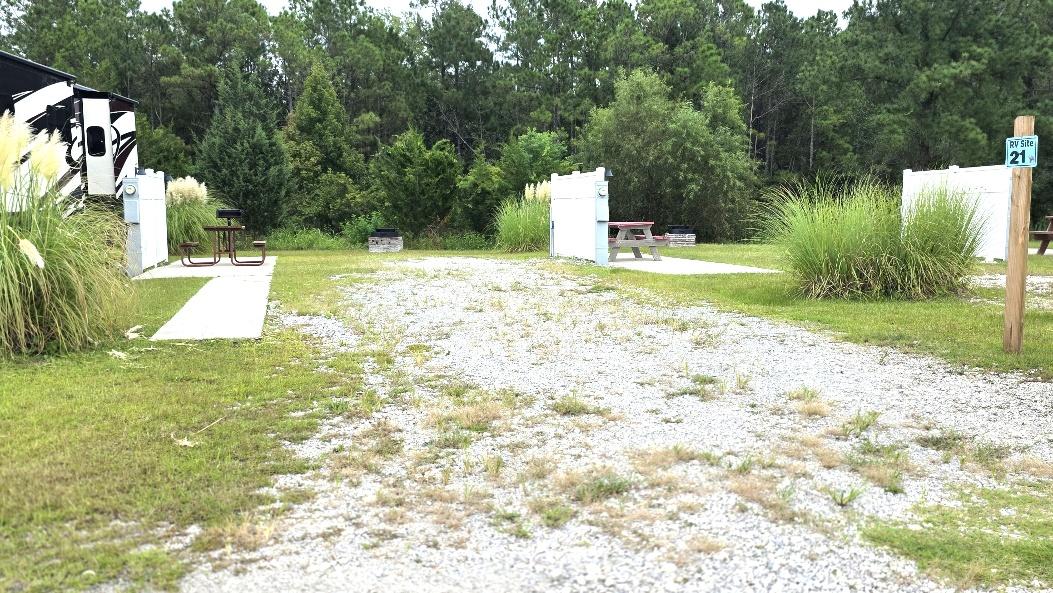 Premium back-in RV site RV21-170 with a concrete walkway