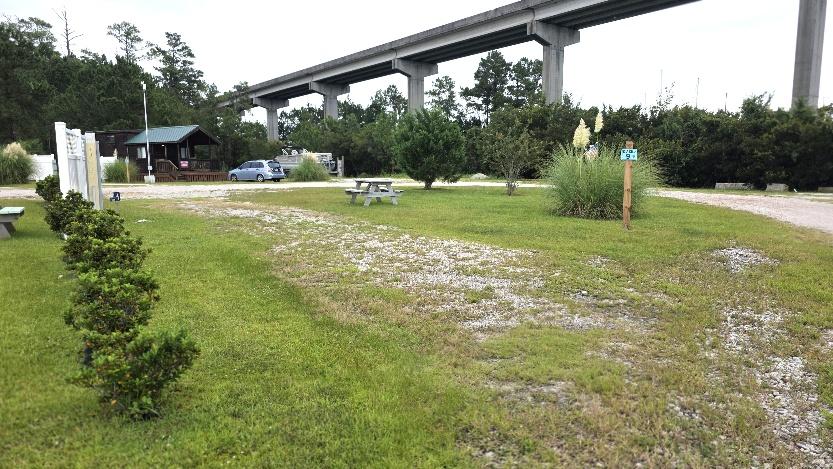 Premium pull-through RV site RV9-161 with a long grassy pad
