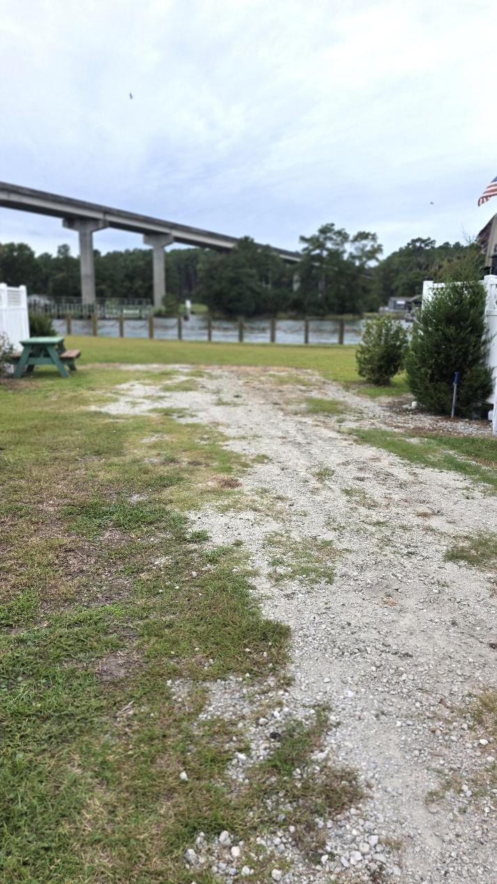 Waterfront RV site RV3-144 with a gravel pad and water view