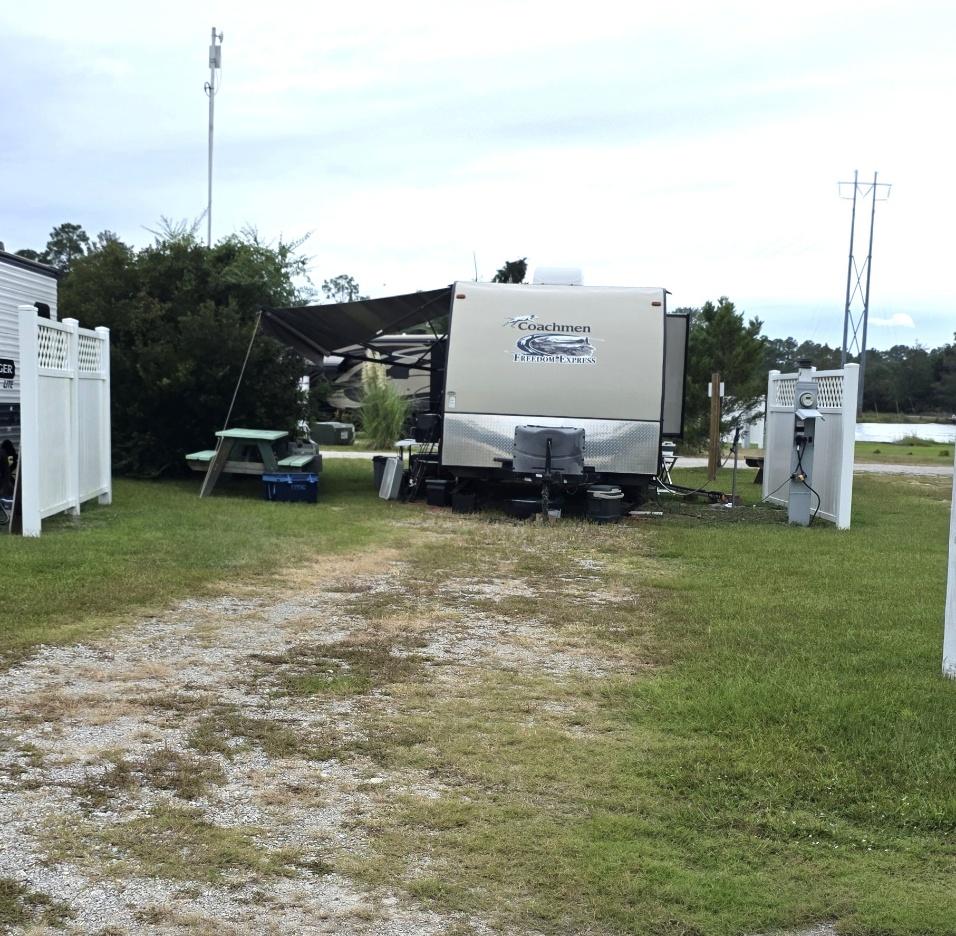 Pull-through RV site RV13-169 with a gravel and grass pad