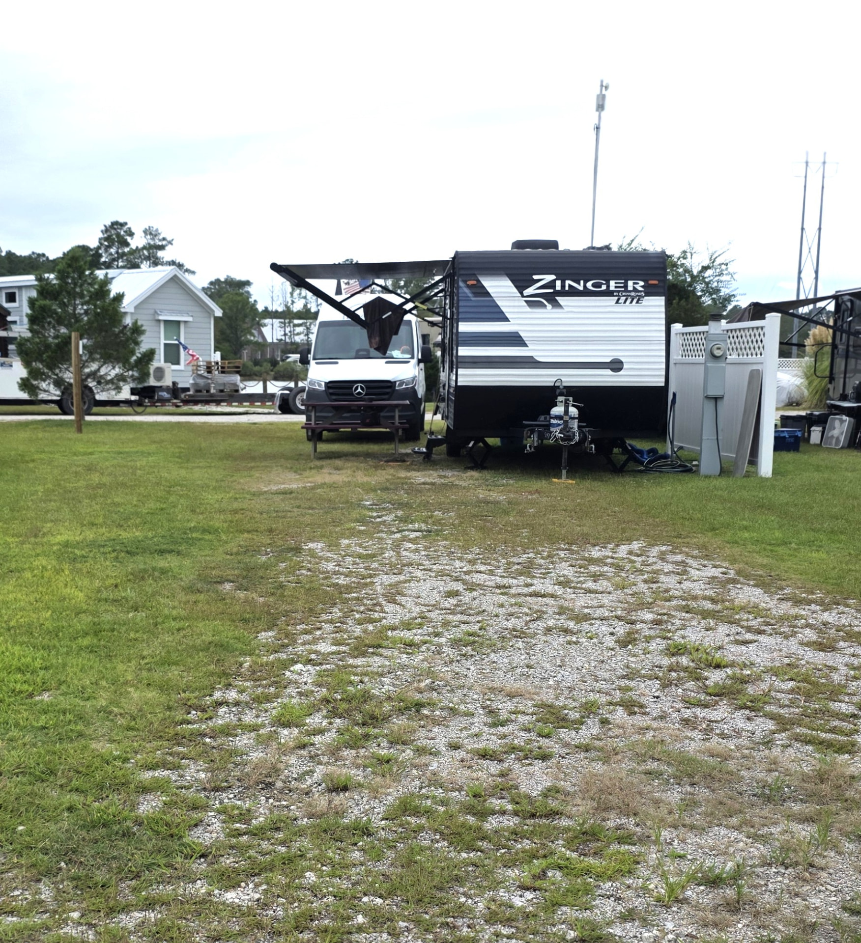 RV site 12 occupied by a travel trailer and camper van